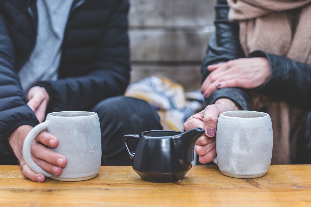 image of two persons having tea together